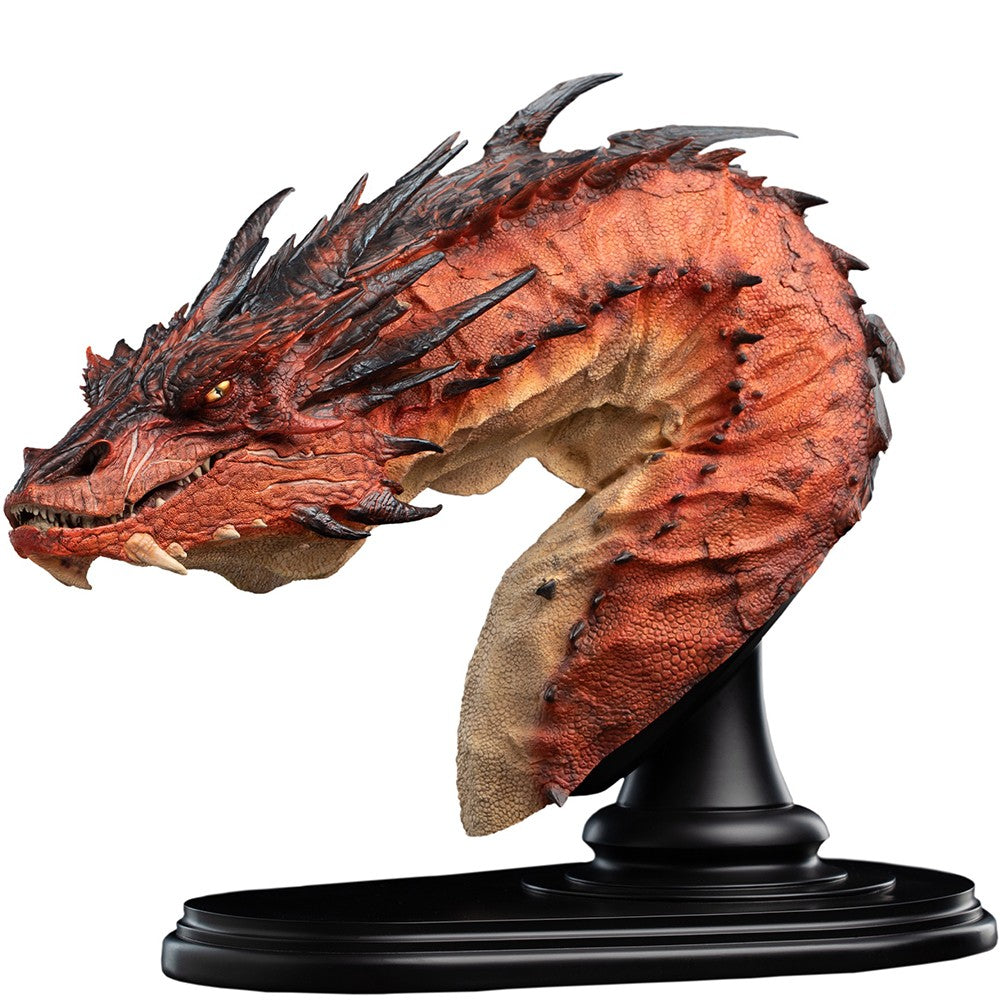 THE HOBBIT - Smaug the Terrible - Bust Edition Statue (Weta Workshop). A highly detailed fantasy dragon bust sculpture on a black display stand, featuring textured orange and red scales with dark spines and a beige underbelly, set against a plain white background.