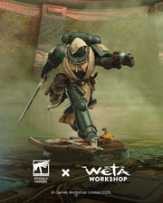 Warhammer 40k - Dark Angels Veteran 1:10 Statue (Weta Workshop). A fantasy armored warrior figurine or collectible character posed mid-step on a base, with a sword in one hand and a blaster in the other. The scene includes Weta Workshop and Games Workshop logos at the bottom, indicating an officially licensed collaboration.