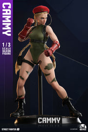 Street Fighter 6 – Cammy 1:3 Scale Silicone Action Figure Statue (Infinity Studio). Street Fighter Cammy 1/3 scale collectible statue on a display stand, featuring her signature green bodysuit, red beret, and black boots against a dark blue background.