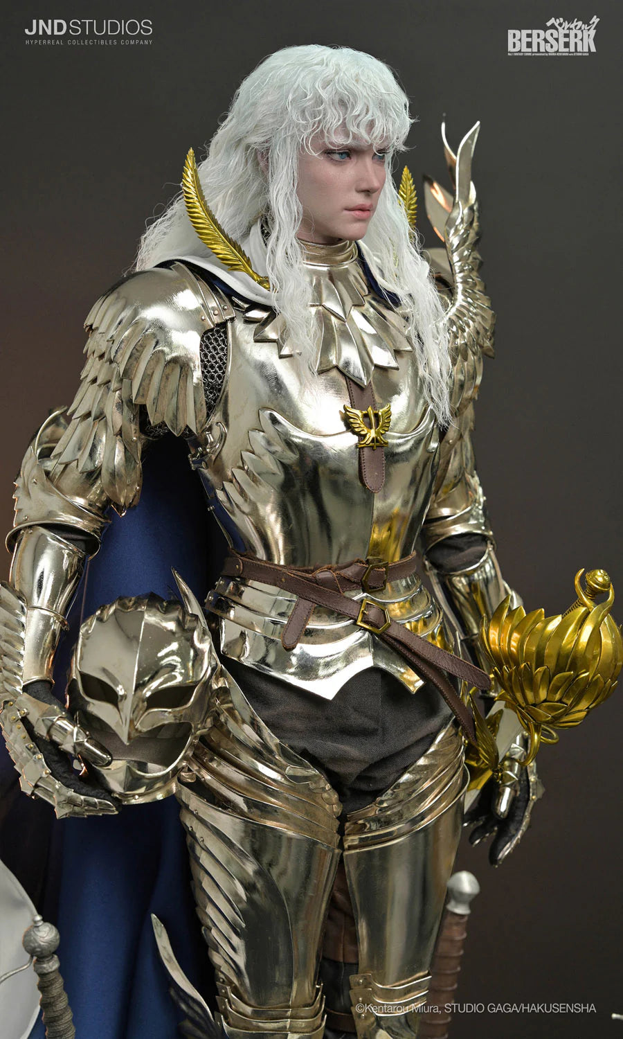A highly detailed collectible statue of a white-haired female warrior in metallic gold armor with gold wing-like shoulder pieces, shown against a dark gray studio background. A white diagonal banner in the bottom right corner features the text 'METAL'. Griffith – Berserk (JND Studios) Metal Armor Deluxe Version 1/3 Scale Statue