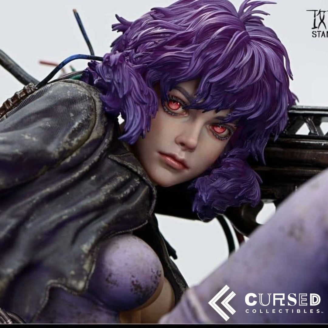 Close-up of Motoko Kusanagi Ghost in the Shell collectible statue featuring realistic facial details, glowing red eyes and purple cyberpunk hair.