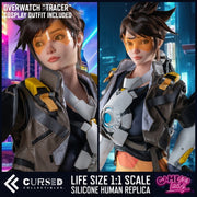 Tracer (Overwatch) Realistic Silicone 1:1 Replica Cosplay Model Doll (Game Lady Studio). Promotional product image for a life-size 1:1 scale silicone human replica of Overwatch's Tracer, shown in a split-screen format with a character render on the left and the figure on the right. Text at the top reads 'OVERWATCH "TRACER" COSPLAY OUTFIT INCLUDED' and the bottom banner shows 'CURSED COLLECTIBLES' and 'LIFE SIZE 1:1 SCALE SILICONE HUMAN REPLICA'. This is not a Overwatch Tracer Sex Doll (but can be upgraded).