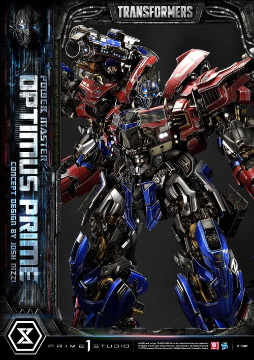 Transformers model of Optimus Prime with branding and studio name on a dark background. Transformers Museum Masterline Statue Powermaster Optimus Prime Concept by Josh Nizzi Ultimate Version 99 cm